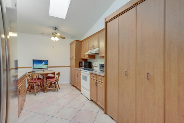 kitchen featuring ceiling fan, vaulted ceiling with skylight, backsplash, light tile patterned flooring, and white electric stove