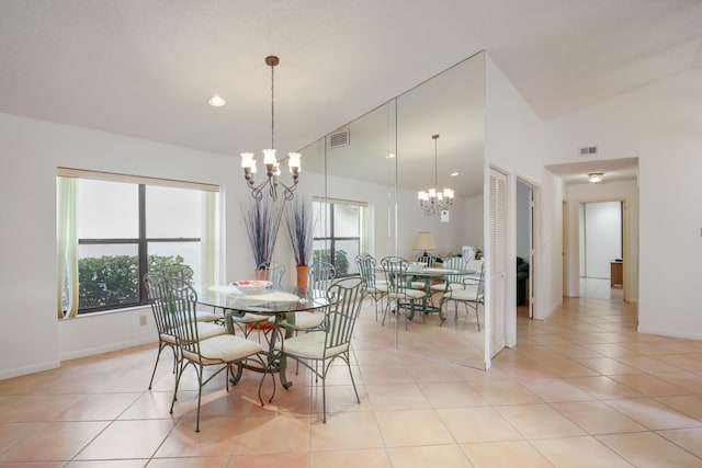 dining room featuring light tile patterned floors, visible vents, and an inviting chandelier