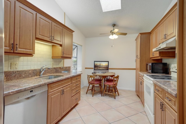 kitchen featuring ceiling fan, dishwasher, white electric range, sink, and light stone countertops