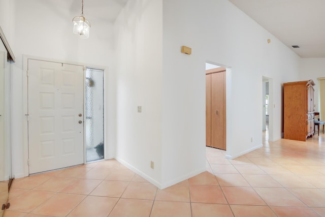 foyer with light tile patterned floors and a high ceiling