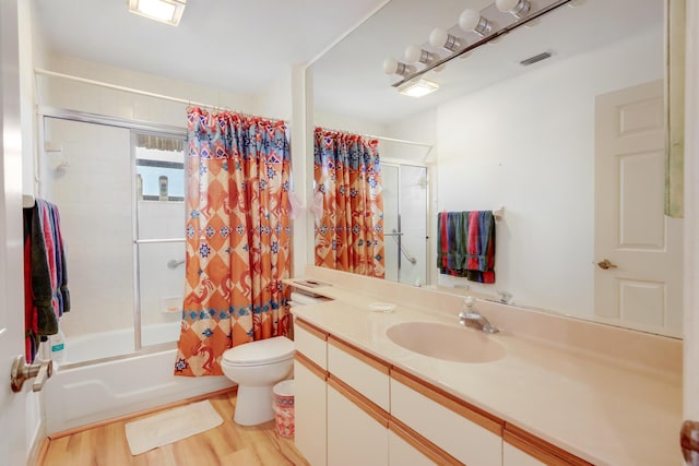 bathroom featuring visible vents, toilet, shower / tub combo, vanity, and wood finished floors