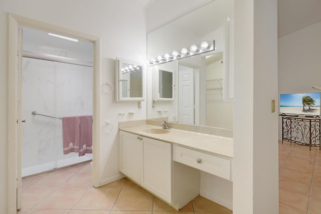 bathroom featuring vanity, baseboards, and tile patterned floors