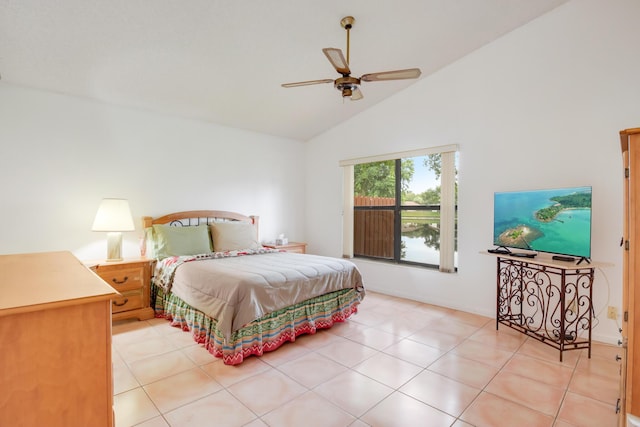 bedroom featuring ceiling fan, light tile patterned floors, and lofted ceiling