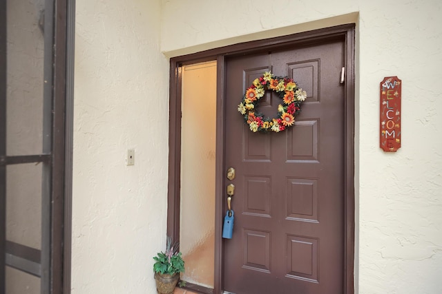 property entrance featuring stucco siding