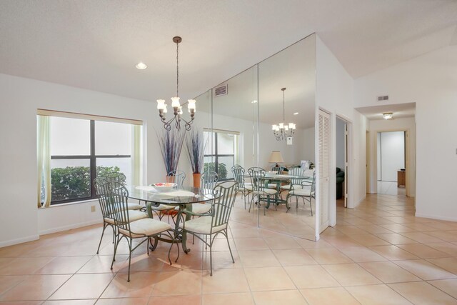 living area with vaulted ceiling, light tile patterned floors, recessed lighting, and a notable chandelier