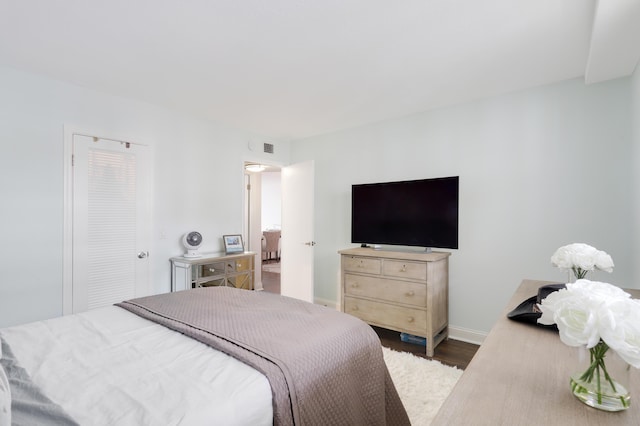 bedroom featuring a closet and dark hardwood / wood-style floors