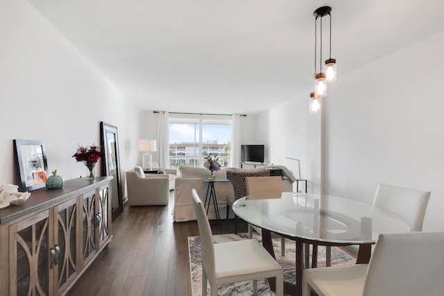 dining space with floor to ceiling windows and dark wood-type flooring