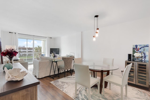 dining area with dark wood-type flooring, a wall of windows, and beverage cooler