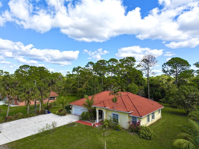 view of front of home with a garage and a front lawn