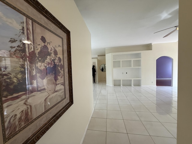 hallway featuring built in shelves and light tile patterned flooring