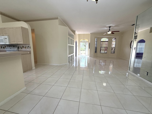 unfurnished living room featuring ceiling fan, light tile patterned floors, and built in shelves