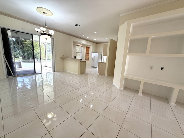 unfurnished room with light tile patterned floors, ornamental molding, and a notable chandelier