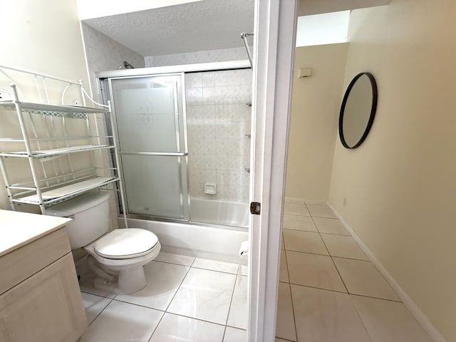 full bathroom featuring a textured ceiling, enclosed tub / shower combo, tile patterned floors, vanity, and toilet