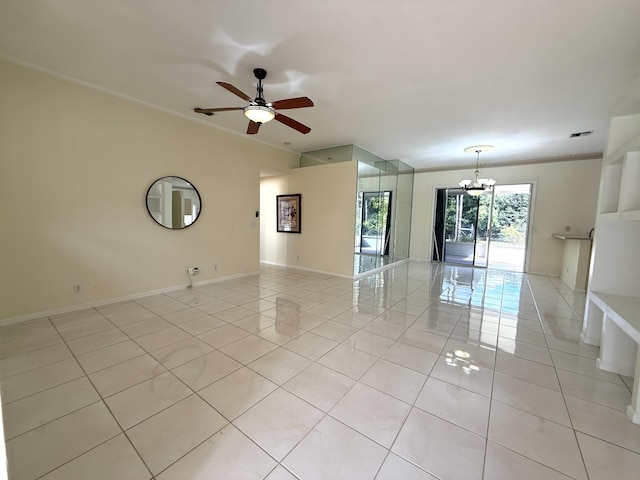 tiled spare room featuring ceiling fan with notable chandelier