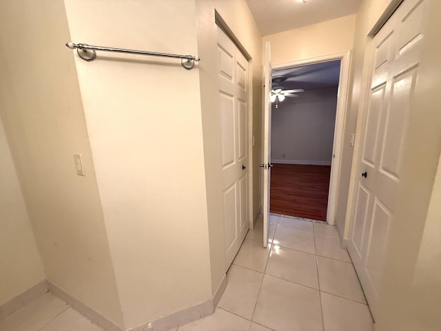 corridor featuring light tile patterned floors