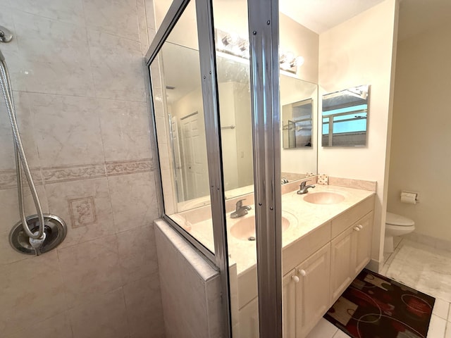 bathroom with tiled shower, tile patterned floors, vanity, and toilet