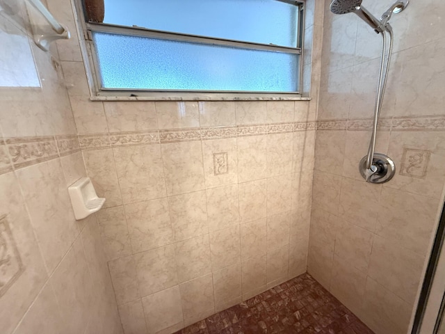 bathroom with a wealth of natural light and a tile shower