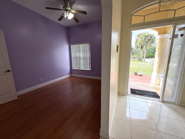 entrance foyer with ceiling fan and tile patterned flooring