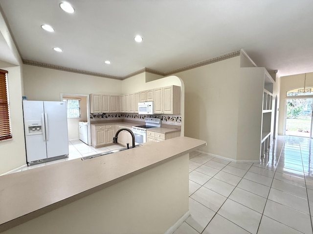 kitchen featuring light tile patterned floors, tasteful backsplash, white appliances, ornamental molding, and sink