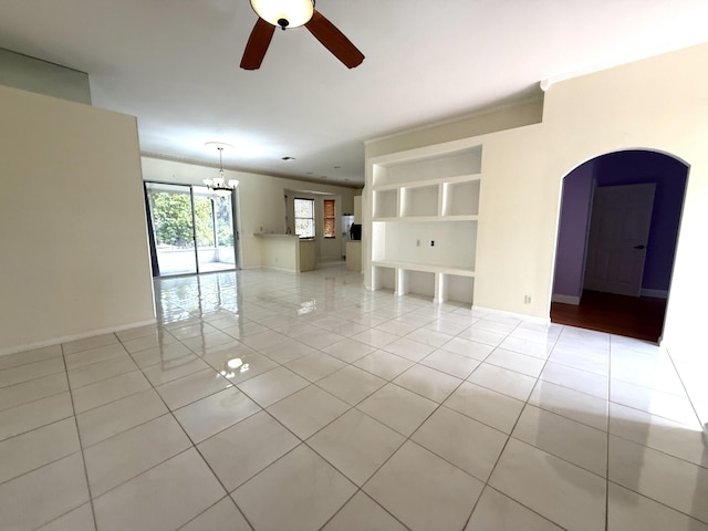 empty room featuring light tile patterned floors and ceiling fan with notable chandelier