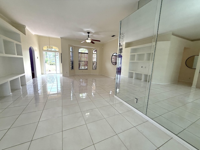 tiled spare room with ceiling fan