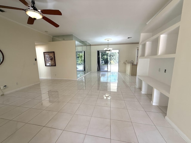 tiled empty room featuring ceiling fan with notable chandelier