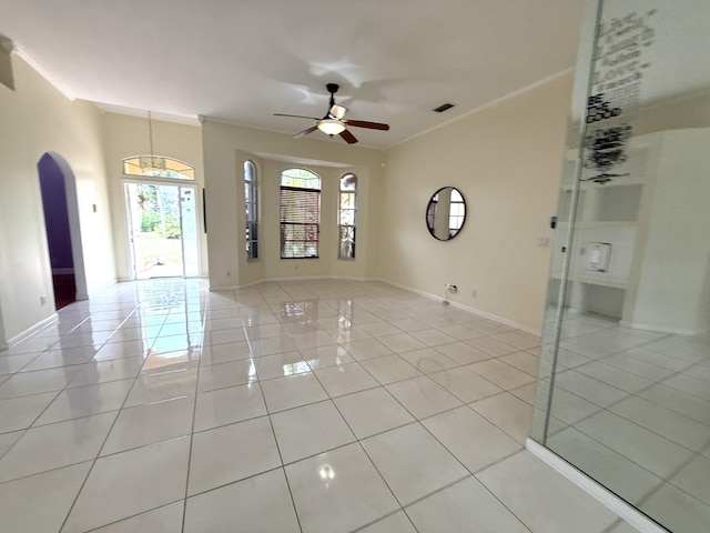 tiled empty room with ceiling fan and ornamental molding