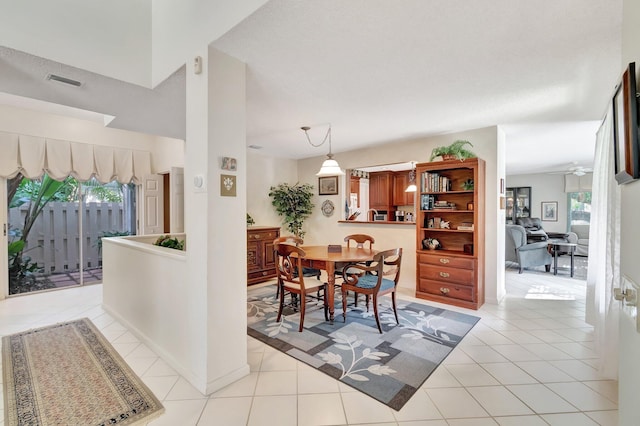 tiled dining area featuring ceiling fan