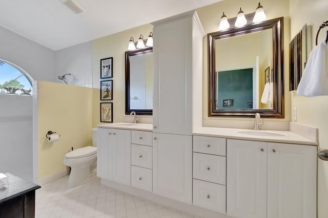 bathroom featuring toilet and vanity