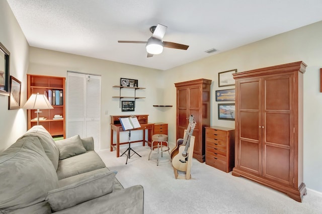 living room featuring ceiling fan and light colored carpet