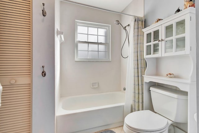 bathroom with toilet, tile patterned floors, and shower / tub combo with curtain