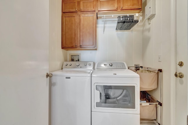 laundry room featuring cabinets, washing machine and clothes dryer, and sink