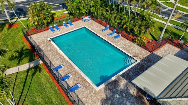 view of pool with a yard and a patio