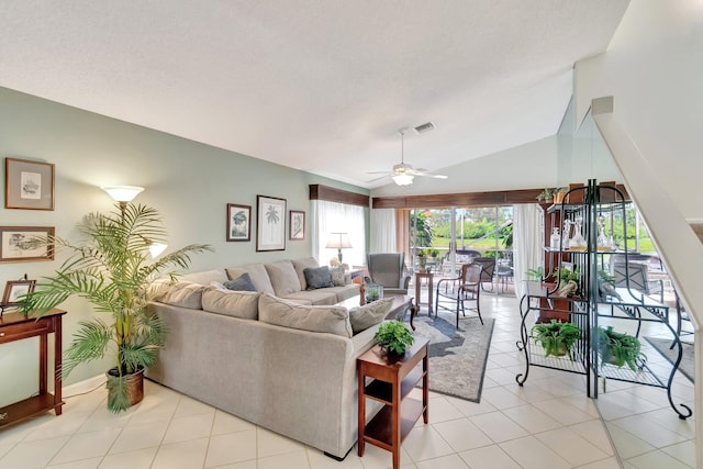 living room featuring ceiling fan, light tile patterned flooring, and lofted ceiling