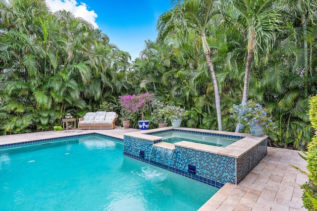 view of swimming pool featuring a patio area and a pool with connected hot tub