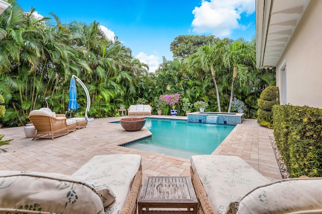 view of swimming pool with a pool with connected hot tub and a patio