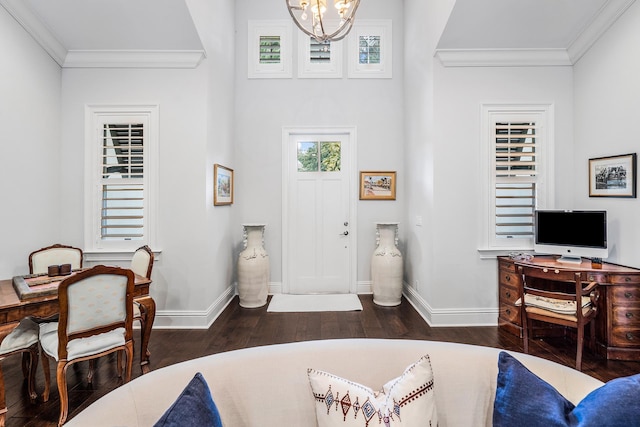 entryway featuring dark wood-style floors, ornamental molding, an inviting chandelier, and baseboards