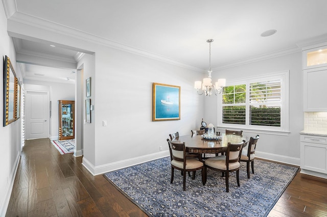 dining area with dark wood-style floors, a notable chandelier, baseboards, and ornamental molding