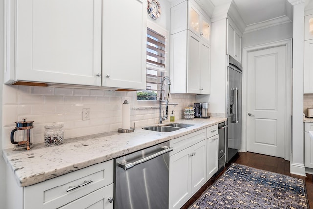 kitchen featuring appliances with stainless steel finishes, a sink, and white cabinets