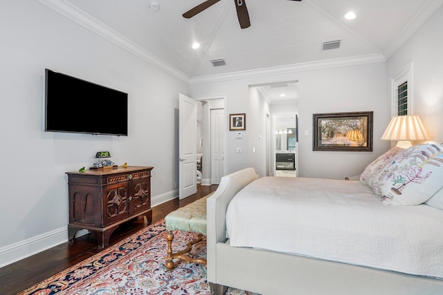 bedroom featuring baseboards, visible vents, lofted ceiling, wood finished floors, and crown molding