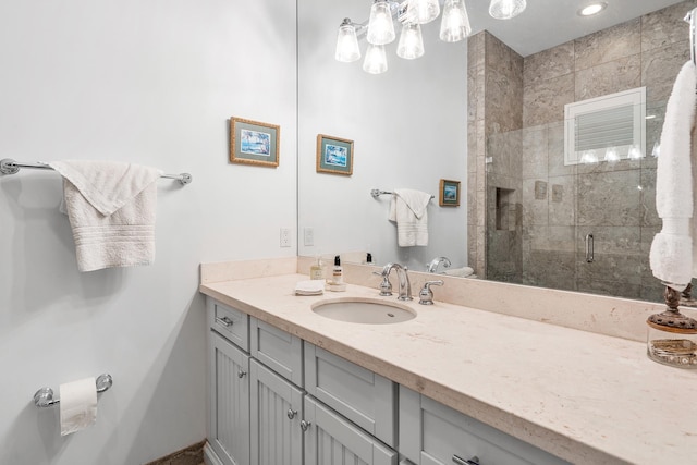 bathroom with a shower stall and vanity