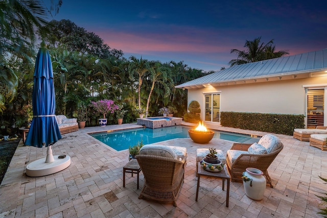 view of pool with a pool with connected hot tub and a patio