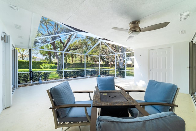 view of patio featuring a lanai and ceiling fan