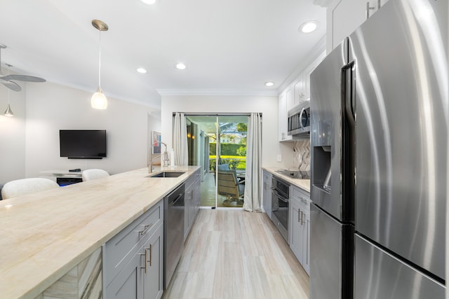 kitchen with sink, gray cabinetry, white cabinetry, ornamental molding, and stainless steel appliances