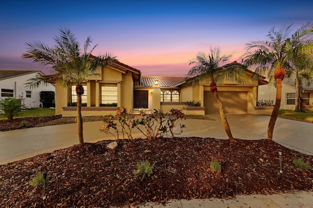 mediterranean / spanish-style home with a garage