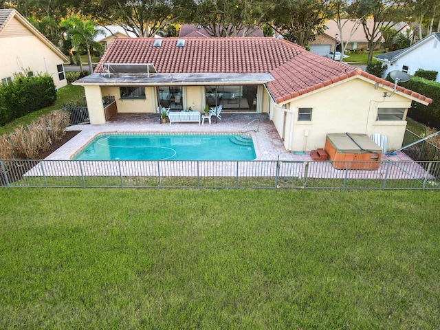 view of pool featuring a hot tub, a patio, and a yard