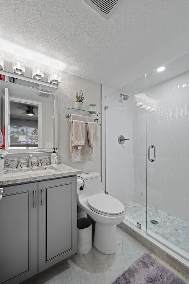 bathroom with walk in shower, vanity, and toilet