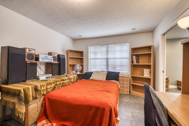 bedroom with tile patterned floors and a textured ceiling