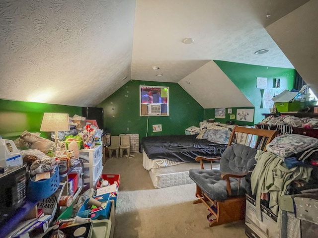 carpeted bedroom featuring a textured ceiling and lofted ceiling