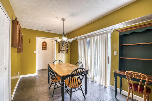 dining room with plenty of natural light, a chandelier, and a textured ceiling